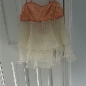 Ballet pink and diaphanous off white adjustable straps and tie back. Never worn